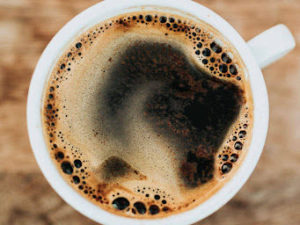 Coffee cup from an aerial view, showing crema bubbling on top.